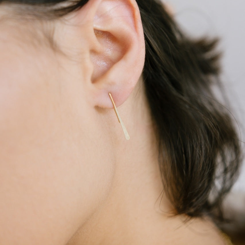 Close up of model&#39;s ear wearing Minimalist Gold Earrings for Women mini thread.