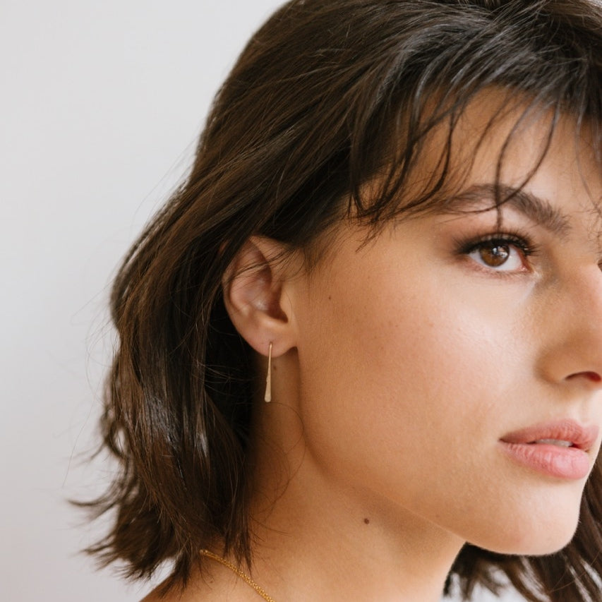 Model wearing Minimalist Gold Earrings for Women that are 1 inch long.