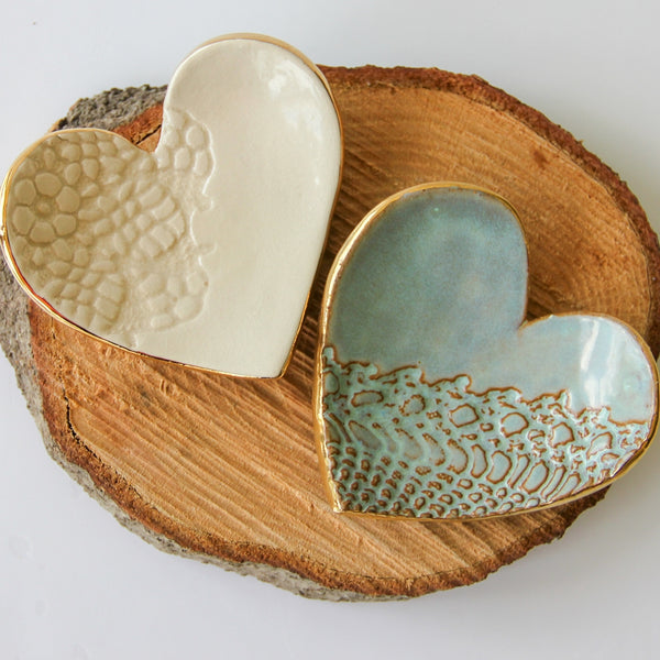 Handmade clay heart ring dish with lace print detail.