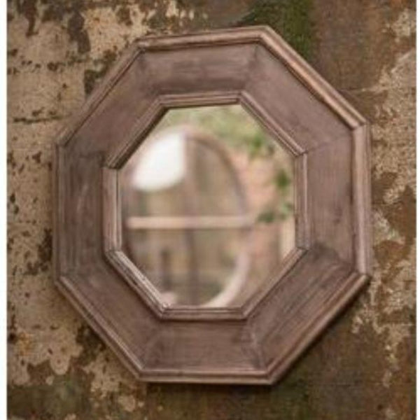 Large wood framed wall mirror displayed on wall.