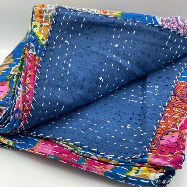 Lightweight queen size quilts with solid blue backing in kantha style.