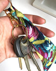 Scarf key chain in lilac floral print hooked to keys.