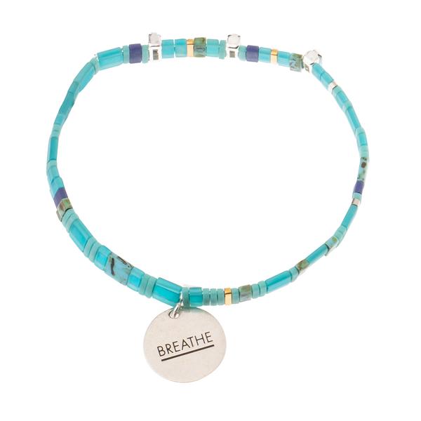 Aqua glass bead bracelet in ocean with sterling silver charm engraved with &quot;breathe&quot;.