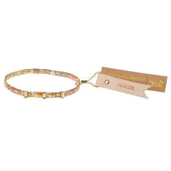 Tortoise shell bracelets with gold engraved charm and reusable leather hang tag stamped with &quot;fearless&quot;.