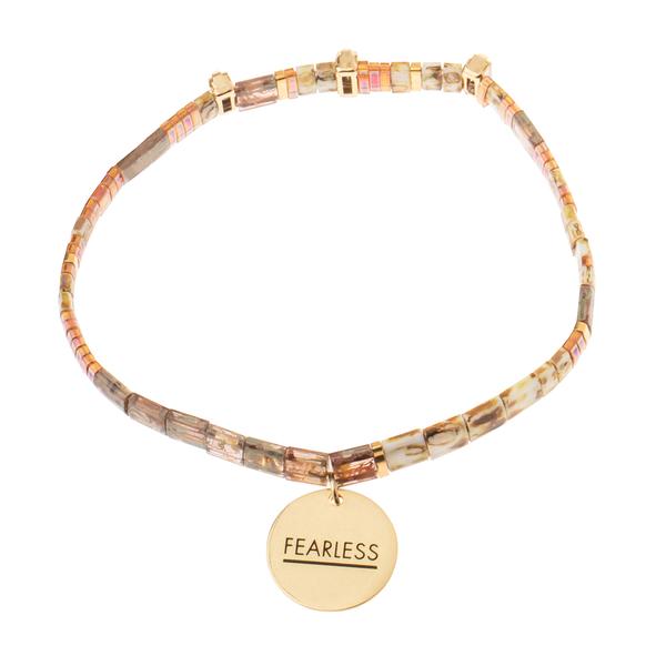 Tortoise shell bracelets with gold charm engraved with &quot;fearless&quot;.