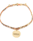 Tortoise shell bracelets with gold charm engraved with "fearless".