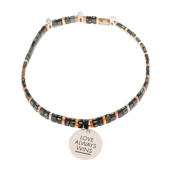 unique Valentine&#39;s gift for significant other. Glass beaded bracelet with silver charm engraved with &quot;Love Always Wins&quot;.