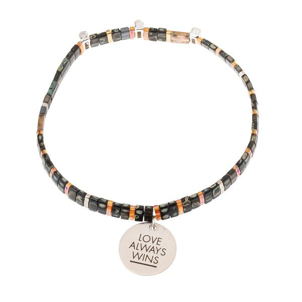 unique Valentine's gift for significant other. Glass beaded bracelet with silver charm engraved with "Love Always Wins".