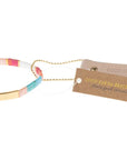 Colorful glass bracelet in miyuki style with leather hang tag stamped with "Good as gold".