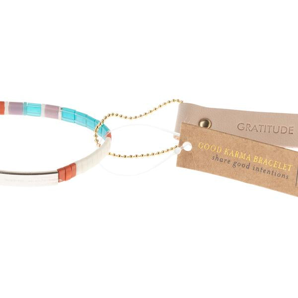 Miyuki bracelets with glass beads in turquoise and orange with "gratitude" stamped on leather reusable hang tag.