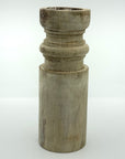 Pillar candle holder tall in barrel shape.