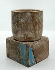 Short square pillar candle holder wood with blue markings.