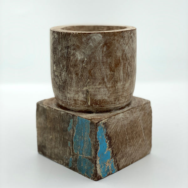 Short square pillar candle holder wood with blue markings.