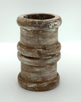 Pillar candle holder wood in short round shape.