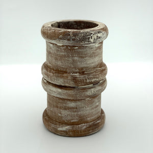 Pillar candle holder wood in short round shape.