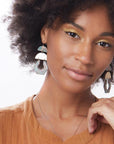 Model wearing gold stone chandelier earrings in aqua terra and gold.