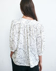 Womens black and white blouse. Back view.