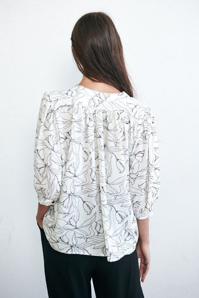 Womens black and white blouse. Back view.
