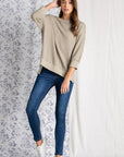 Women's loose fit tops paired with denim.