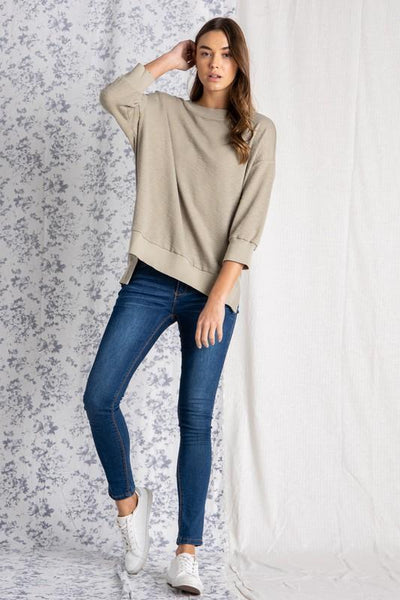 Women's loose fit tops paired with denim.