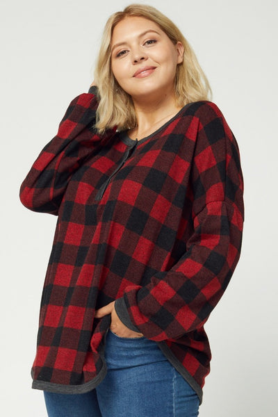 Women's plus size buffalo plaid pajamas paired with jeans.