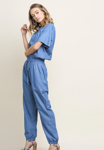 Womens short sleeve jumpsuit in chambray side view.
