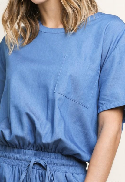 Womens short sleeve jumpsuit in chambray close up view of top.