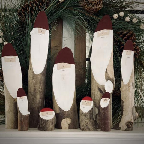 Wooden Santa logs displayed in a group.