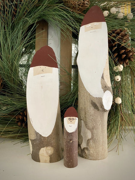 Three wooden Santa logs in small, medium, and large sizes. Large is 9-16 inches tall.