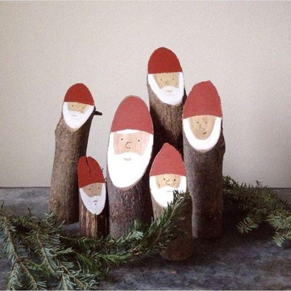 A smaller group gathering of wooden Santa logs.