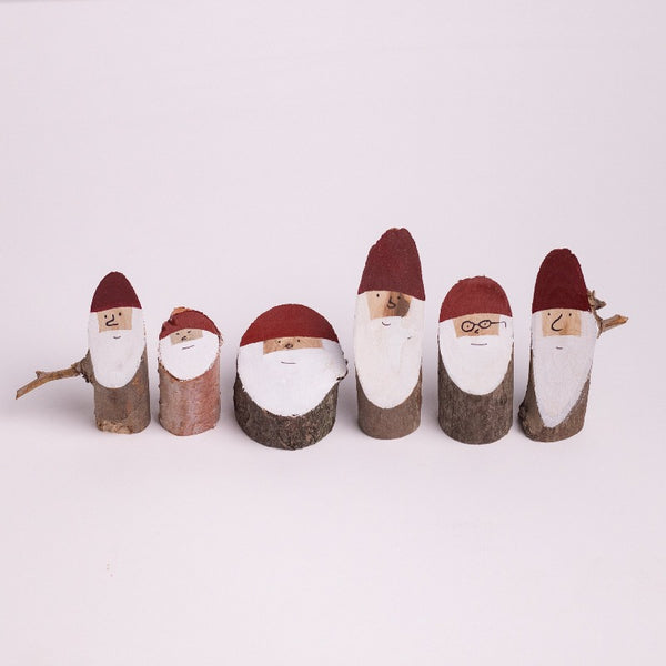 Wooden Santa logs in small size. 1-4 inches tall.