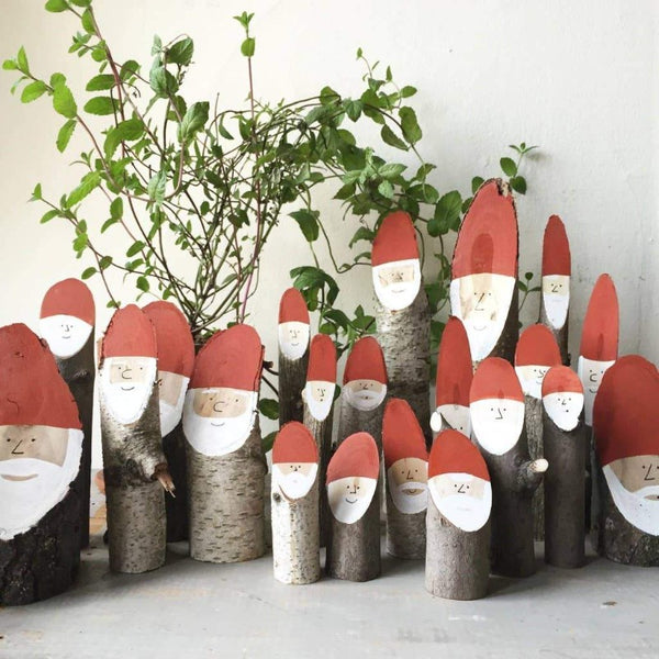 A gathering of the wooden Santa logs.